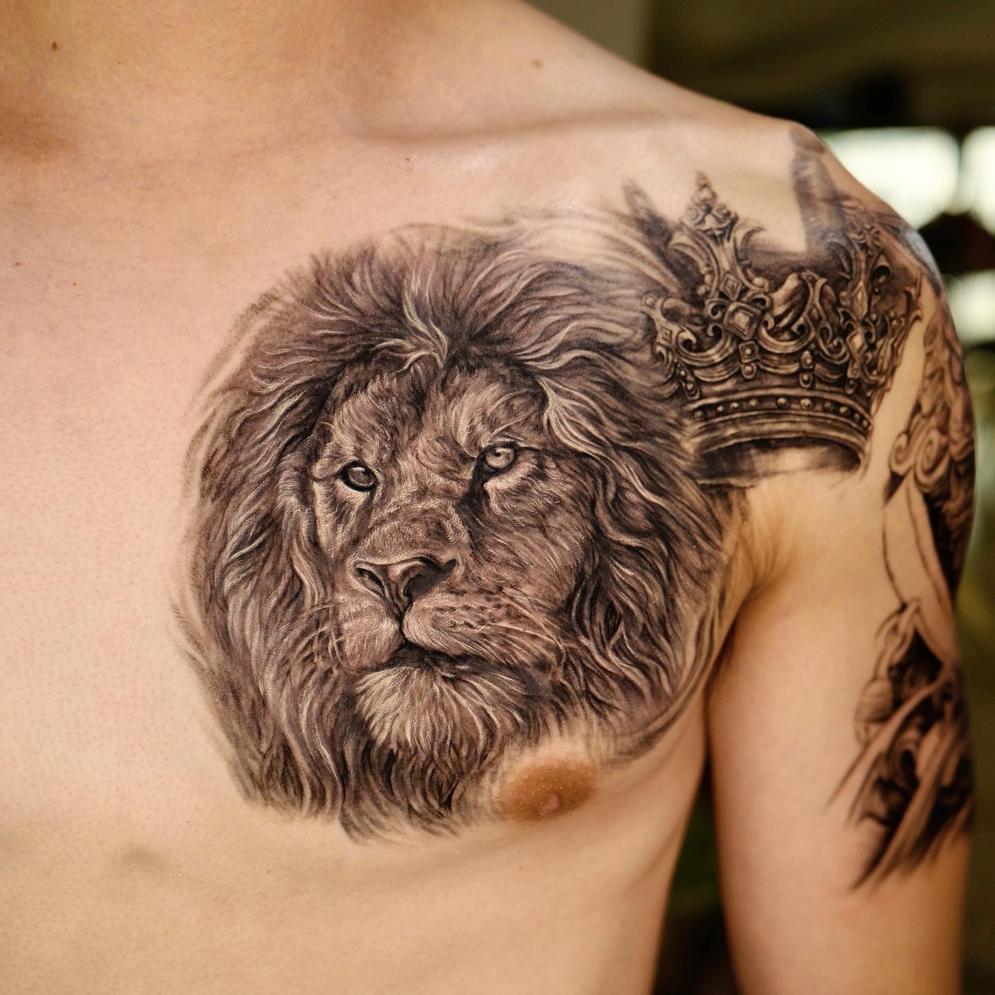 Lion Head and Crown Tattoo on Chest