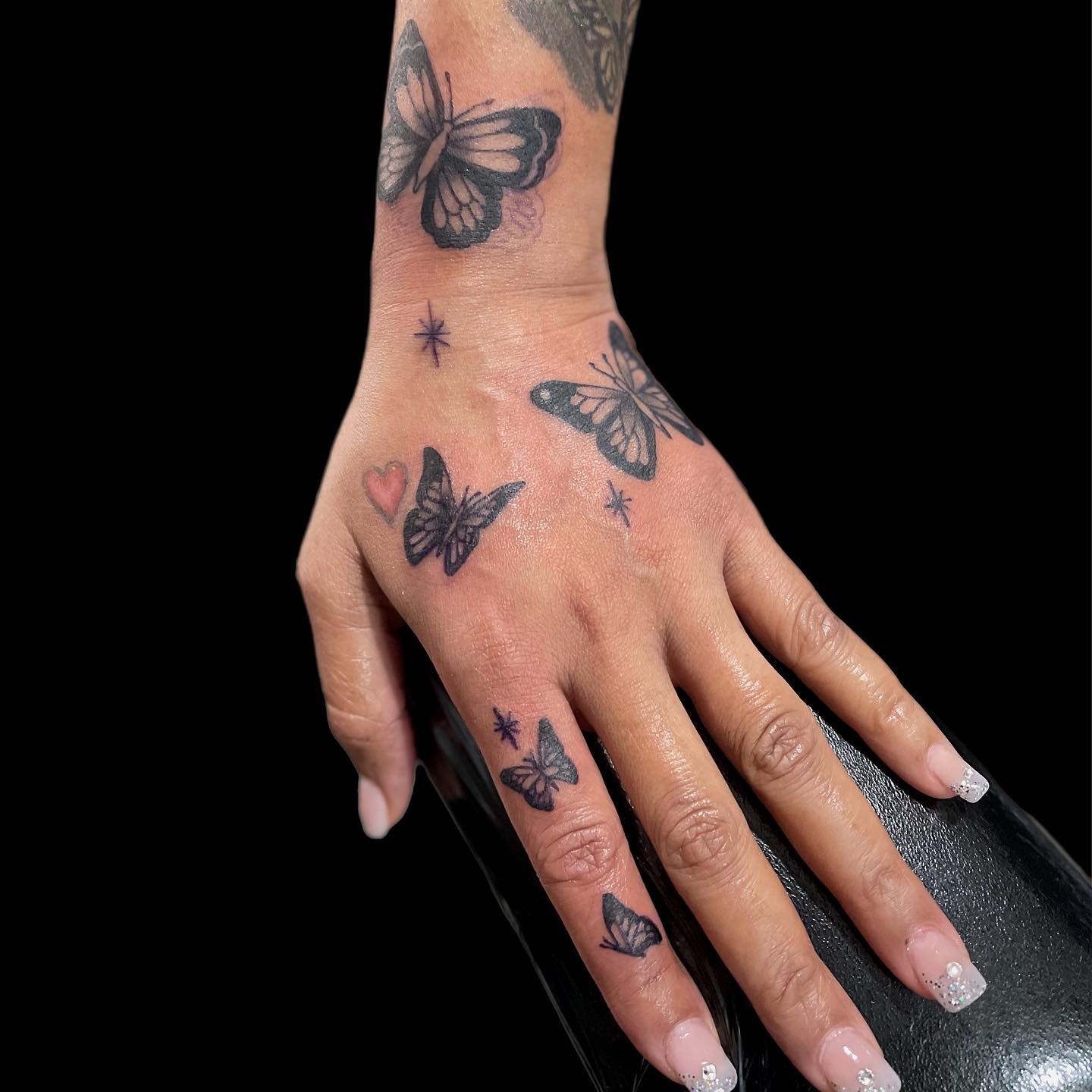 Multiple Blue Butterfly Tattoos on Hand