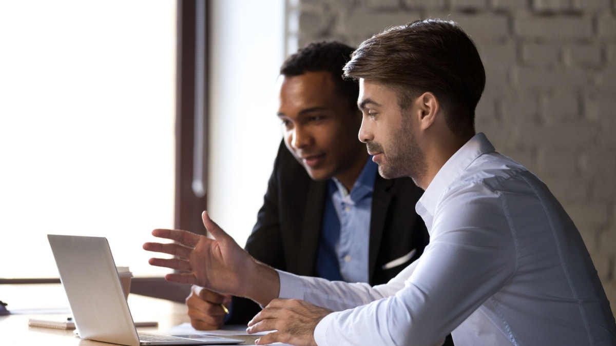 A Hawk Ridge Systems customer is speaking and reviewing software solutions with their account manager in a breakthrough meeting.