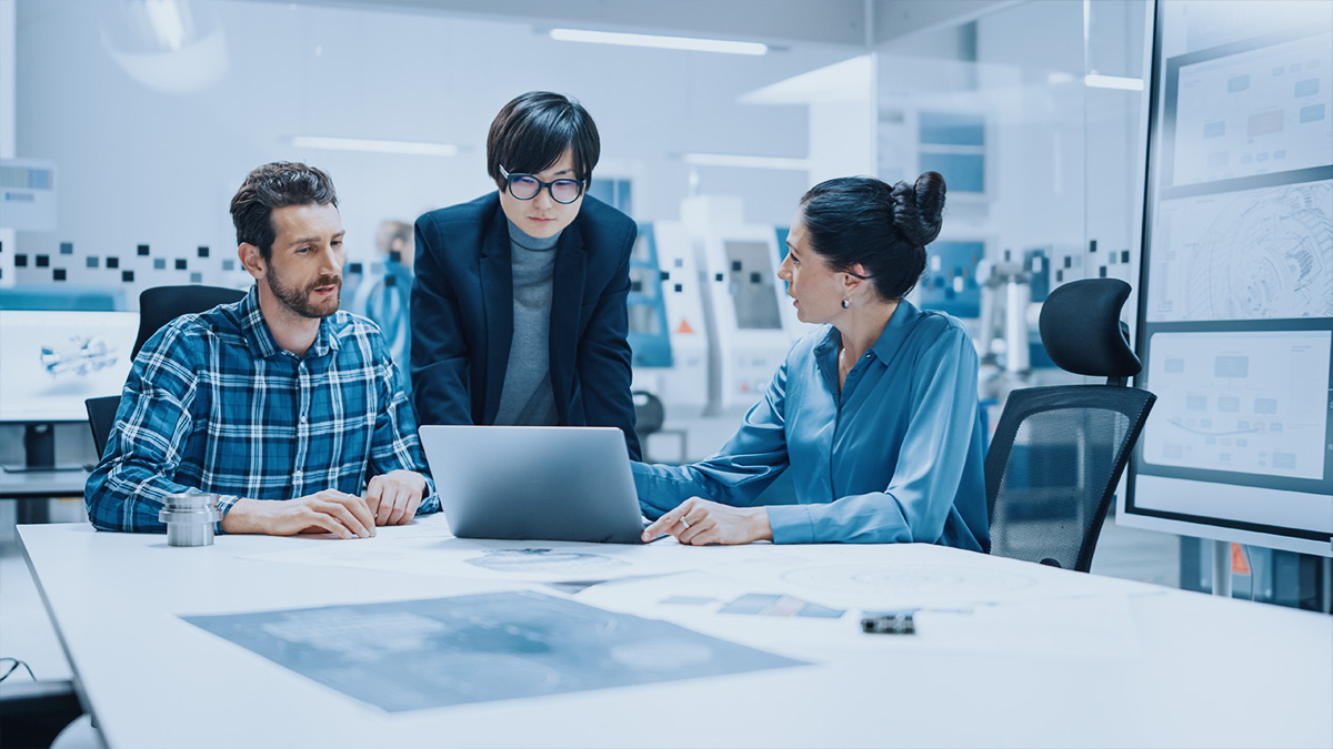 engineers collaborating around laptop