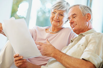 Senior Couple Reviewing Prop 90 Information